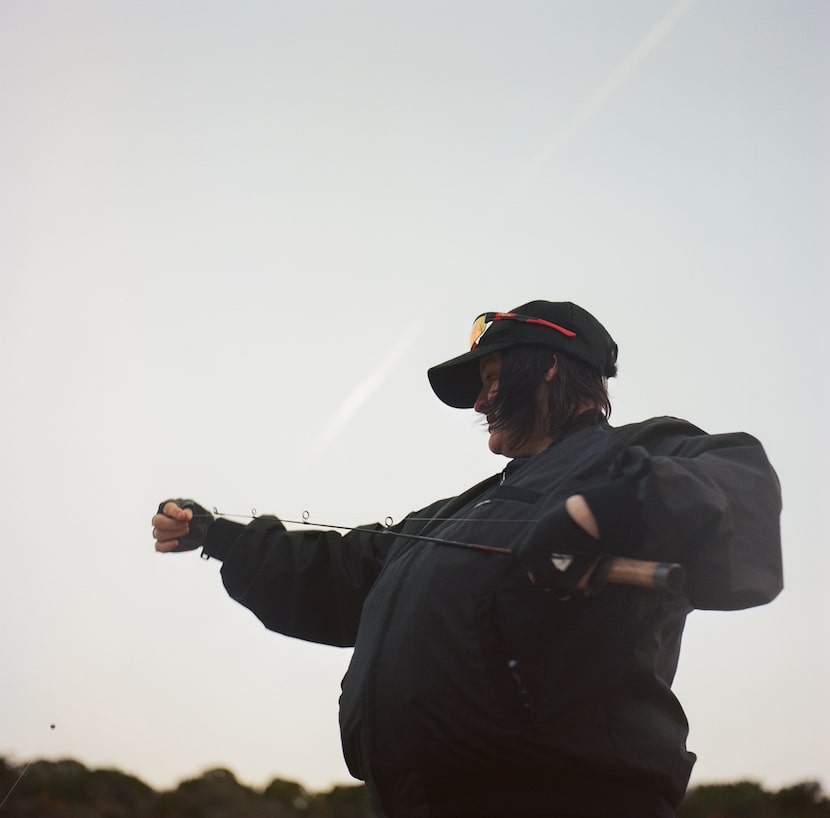 Jax Squire prepares his fishing line on Monday, Dec. 15, 2025 at a creek outside of Graford,...