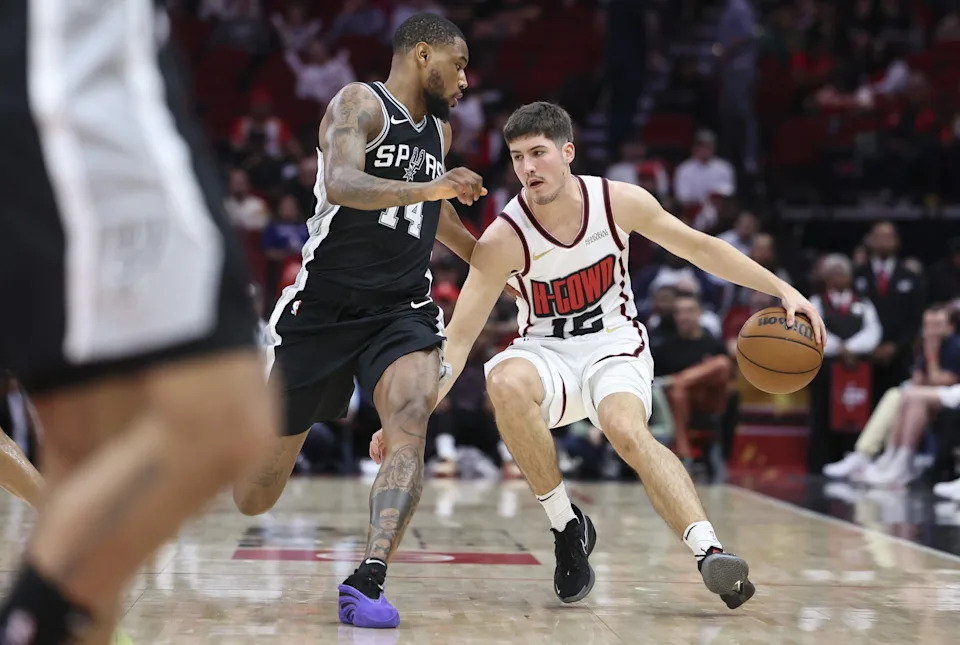 Feb 26, 2025; Houston, Texas, USA; Houston Rockets guard Reed Sheppard (15) dribbles the ball as San Antonio Spurs guard Blake Wesley (14) defends during the fourth quarter at Toyota Center. Mandatory Credit: Troy Taormina-Imagn Images