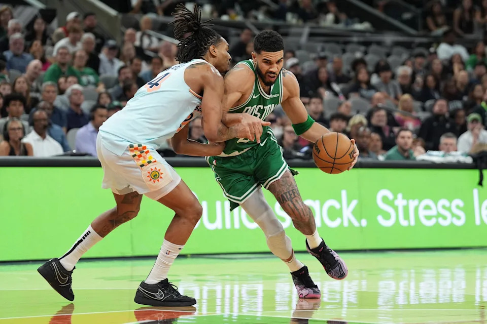 Mar 29, 2025; San Antonio, Texas, USA; Boston Celtics forward Jayson Tatum (0) dribbles against San Antonio Spurs guard Devin Vassell (24) in the second half at Frost Bank Center. Mandatory Credit: Daniel Dunn-Imagn Images