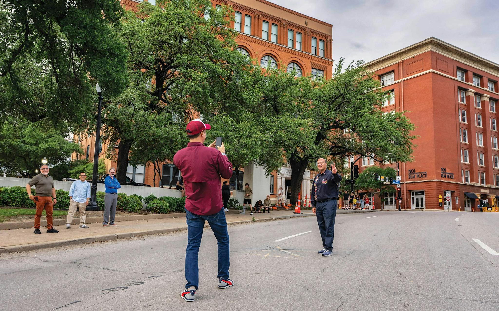 May 10 7:24 P.M. Miguel Acosta taking a photo of Natividad Castrejón Valdez in Dealey Plaza, where President John F. Kennedy was assassinated. Both men were visiting from Pachuca de Soto, Mexico.