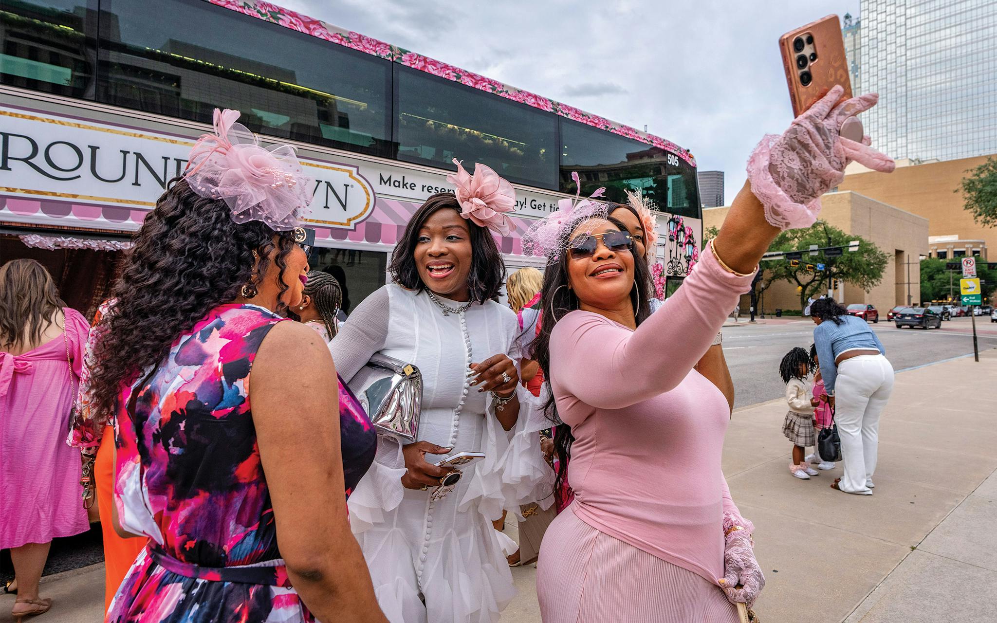 May 10 7:32 P.M. A group of friends snaps a selfie before boarding the Tea Around Town bus on Main Street in John F. Kennedy Memorial Plaza.