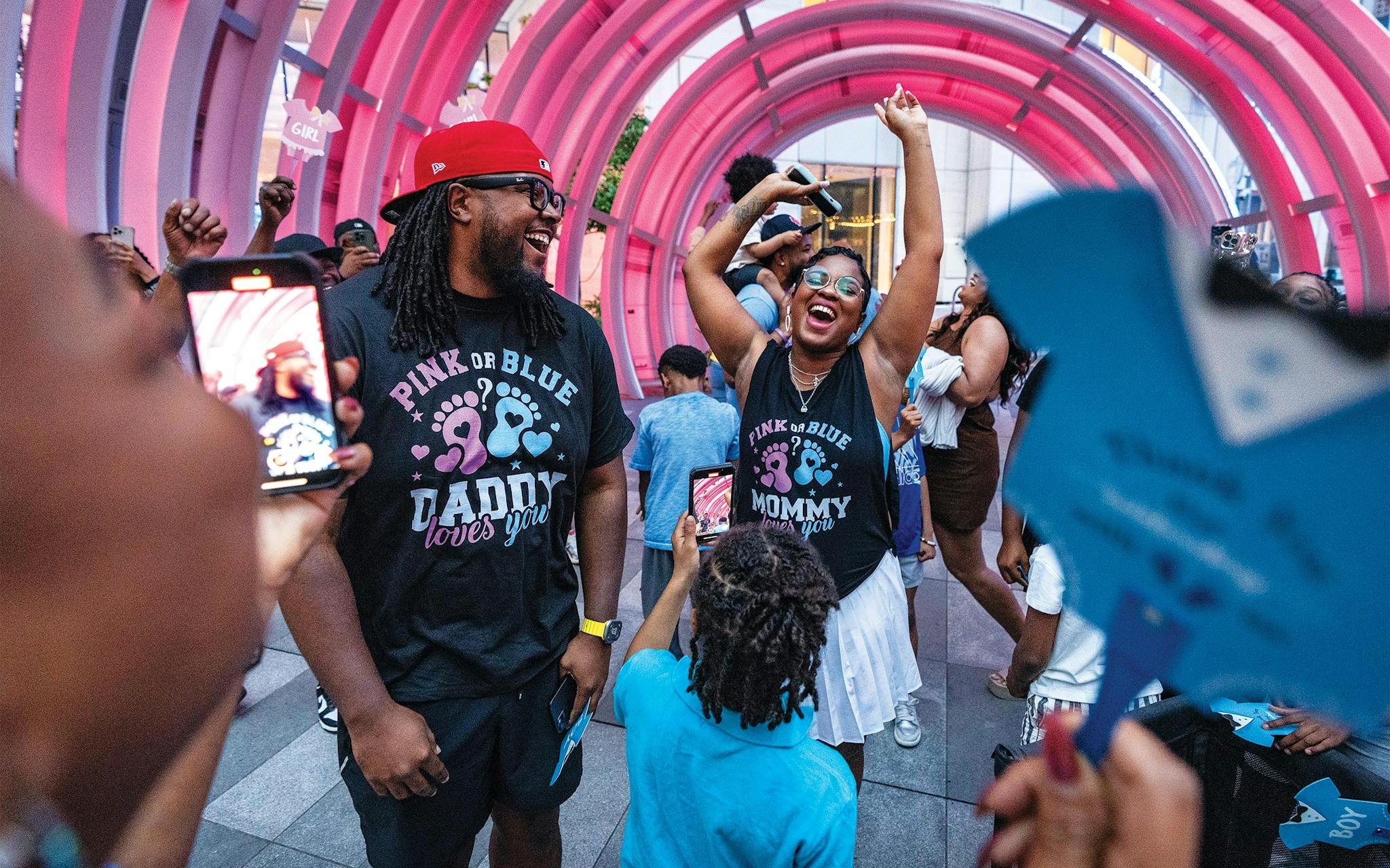 May 10 8:13 P.M. Justin White and his wife, Ariel, celebrating at the AT&T Discovery District after learning that they’re having a baby girl. Justin, who works for AT&T, had arranged for lights in the plaza to turn pink or blue for the reveal.