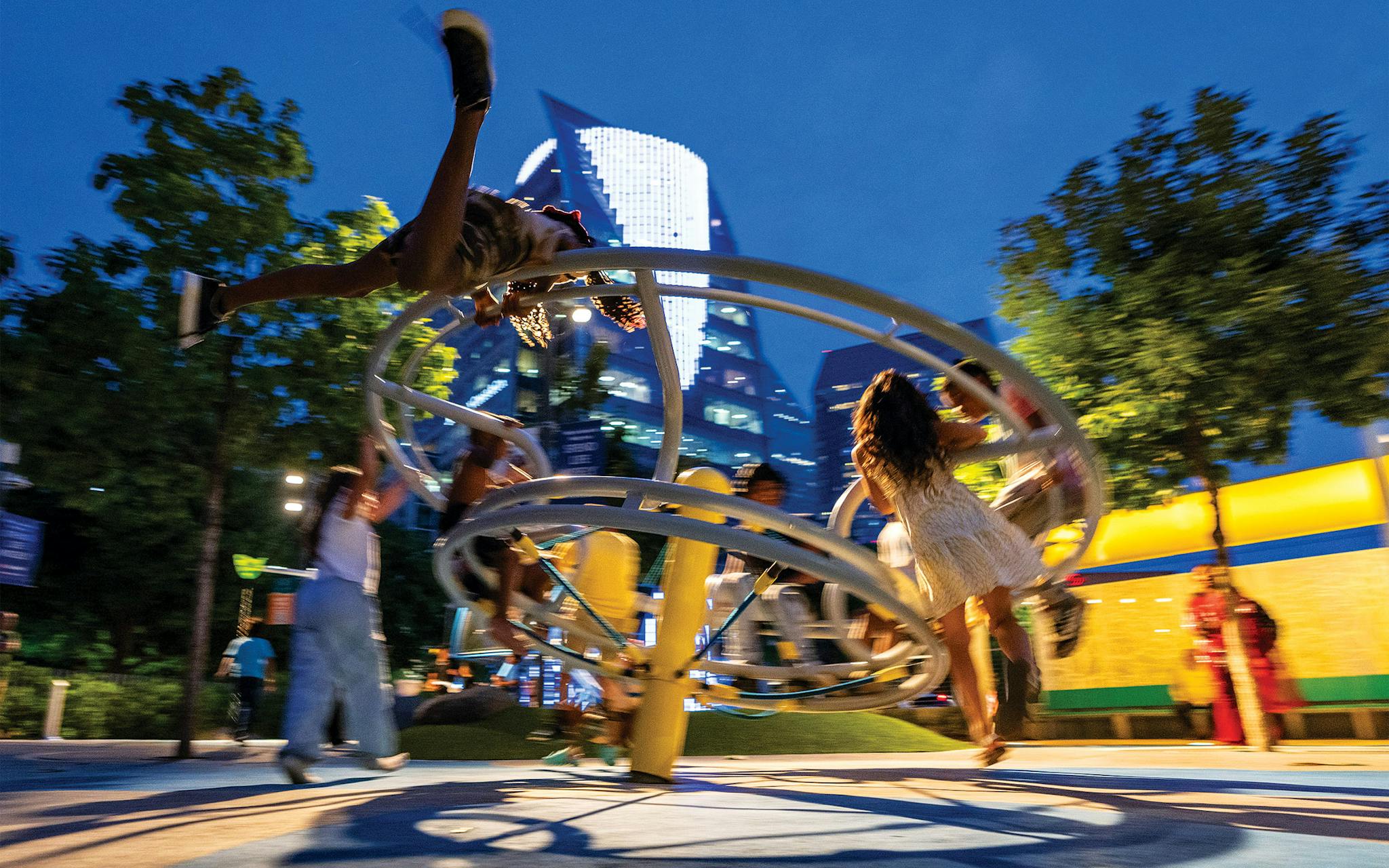 May 10 8:38 P.M. Kids spinning at the playground at Klyde Warren Park.