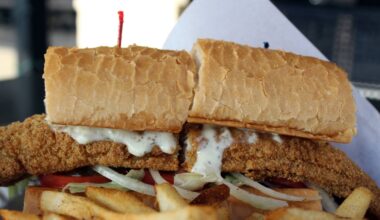 Fried catfish sandwich with side of fries.