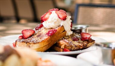 Bread Winners Cafe & Bakery's menu includes items such as the Normandy French Toast, which has sliced sourdough stuffed with cream cheese and raspberry jam and is topped with fresh berries and whipped cream. (Courtesy Bread Winner Cafe & Bakery Facebook)