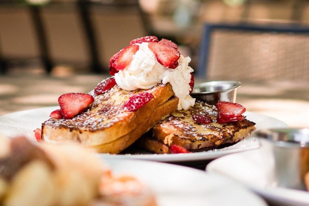Bread Winners Cafe & Bakery's menu includes items such as the Normandy French Toast, which has sliced sourdough stuffed with cream cheese and raspberry jam and is topped with fresh berries and whipped cream. (Courtesy Bread Winner Cafe & Bakery Facebook)