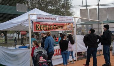 people in line at a tent selling kettle corn