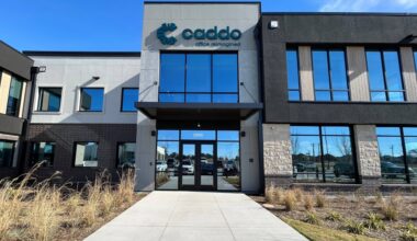 Exterior of a freestanding two-story building featuring Caddo signage.
