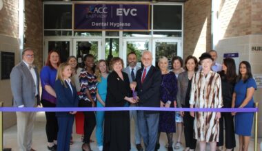 People cut a ribbon at a ceremony