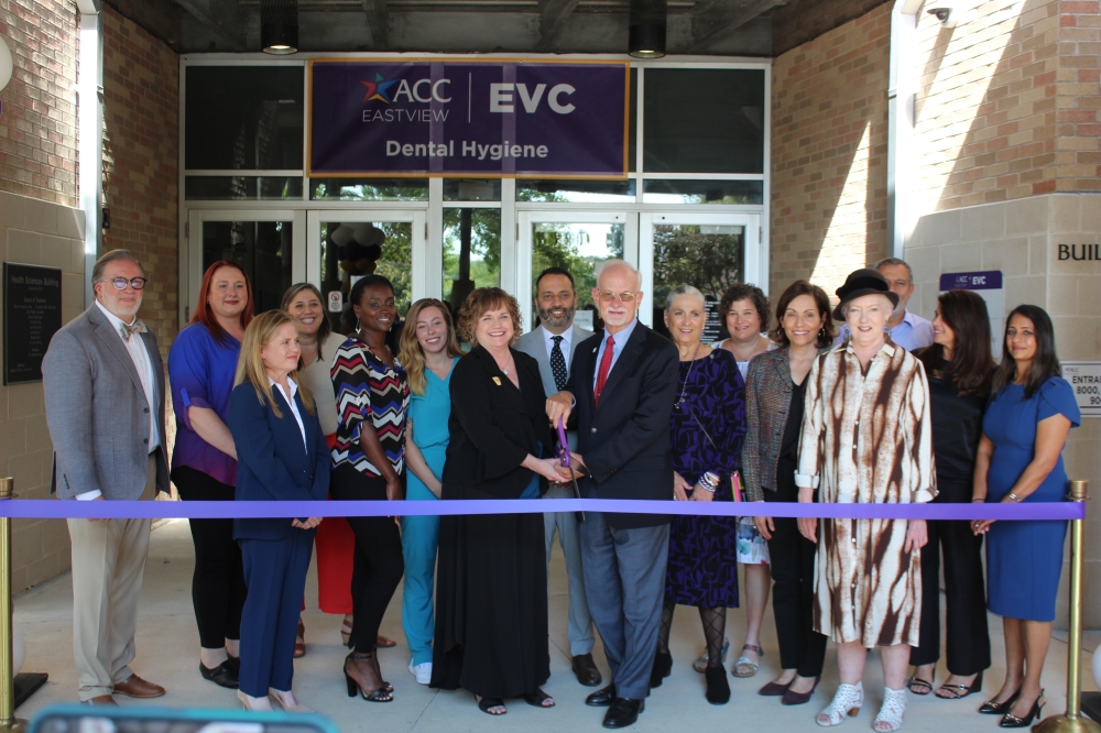 People cut a ribbon at a ceremony