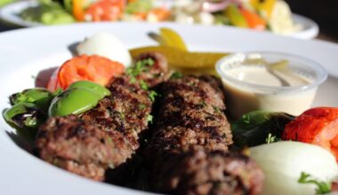 a plate with beef kabobs and fresh vegetables