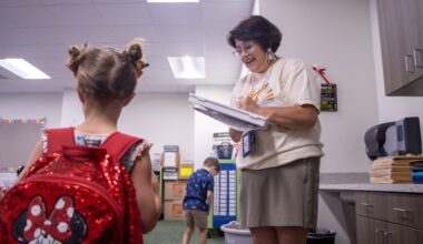 Shelly Gallus, kindergarten teacher at Olson Elementary School, welcomes students to class on the first day of school in August 2025.