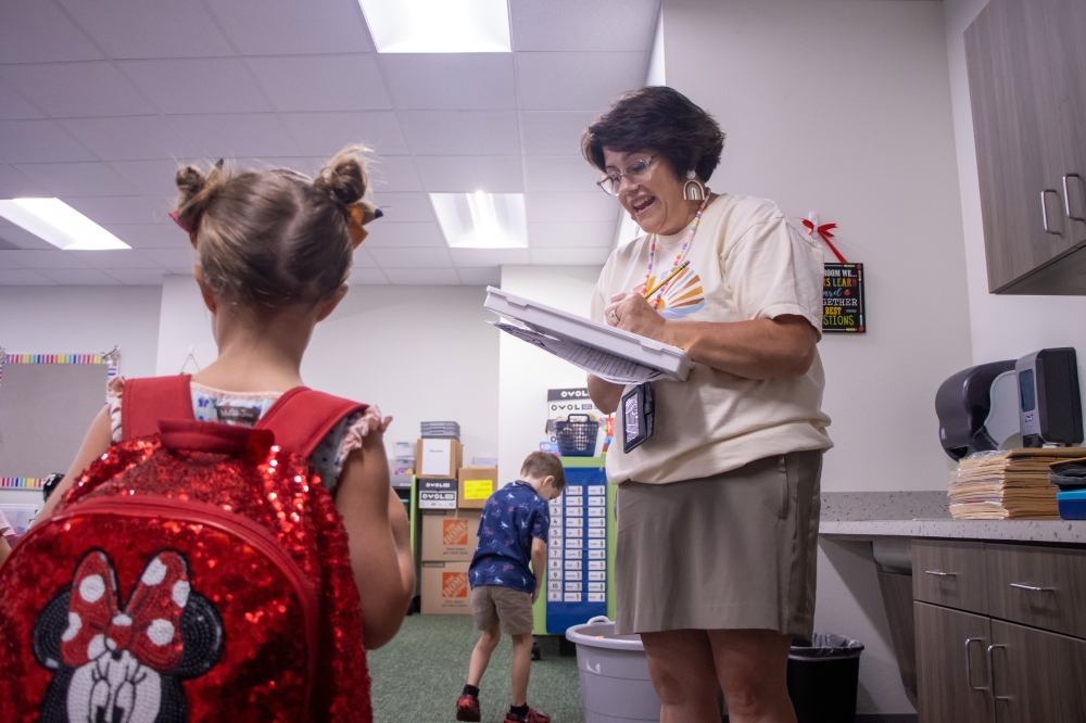 Shelly Gallus, kindergarten teacher at Olson Elementary School, welcomes students to class on the first day of school in August 2025.