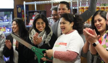 People cut a ribbon and clap their hands