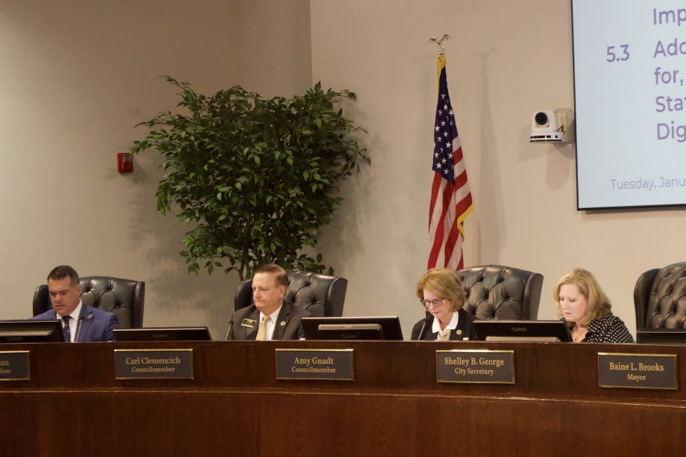 Members of Allen City  Council sitting in a meeting