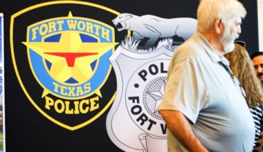 Man in front Fort Worth Police Department sign