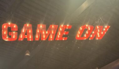 A light up sign on the ceiling that says "Game On"