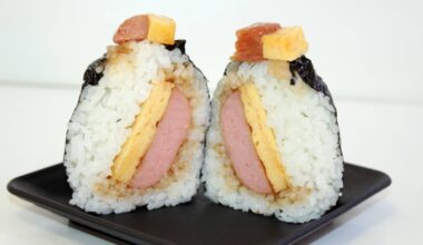 Onigiri cut in half showing rice, spam and eggs.