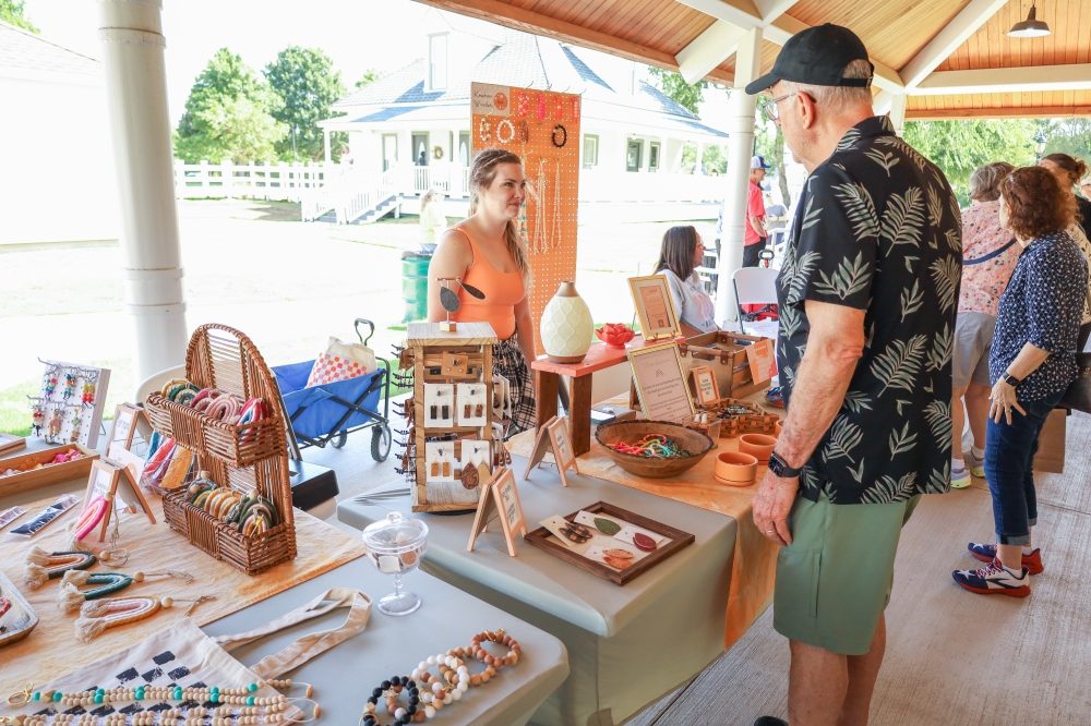 Woman and man talking at Allen cottage market