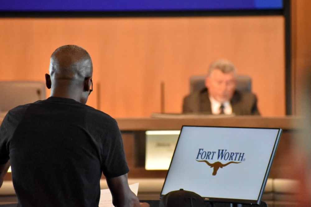man speaking at city council
