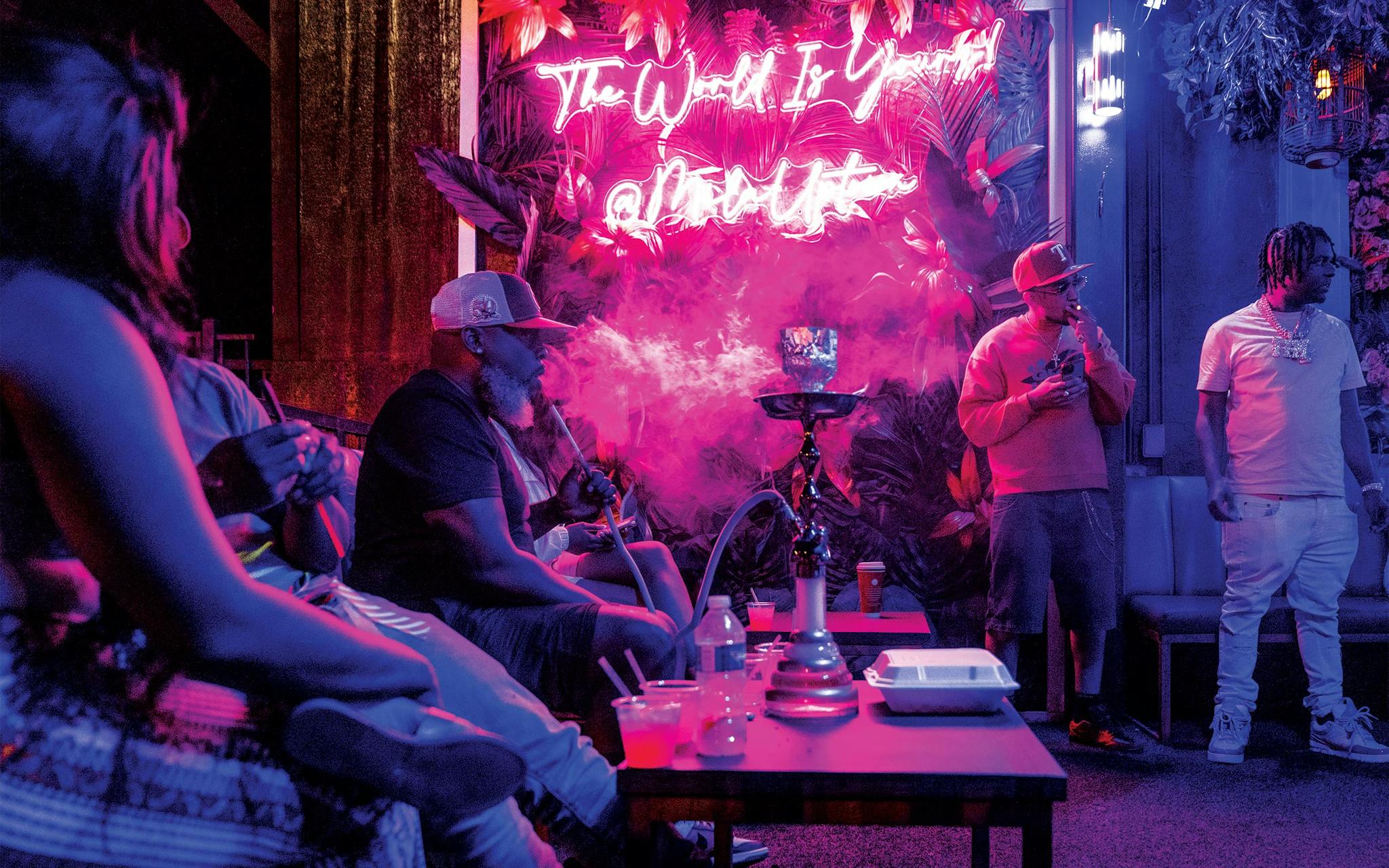 May 10 9:42 P.M. Patrons smoking hookah on the patio of Mila, a club in Uptown.