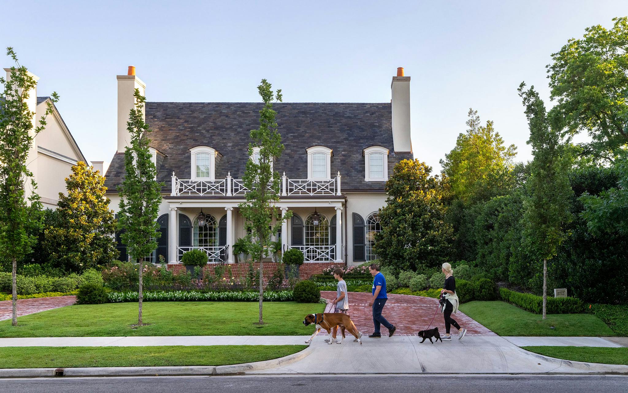 May 31 7:30 A.M. Gina Alegre, 52, her husband Daniel Alegre, 56, and their son Daniel Alegre, 14, walk their 8-year-old boxer Puppy (left) and 11-year-old pug, Penny, along Miramar Avenue in Highland Park. The Alegres, having moved from San Francisco in 2021, have experienced some culture shock in Highland Park, which Daniel likened to the fictional town of Mayberry from “The Andy Griffith Show.” “This doesn't feel like the real America, when a policeman is calling you to tell you that your right window’s ajar. It's nice, but you step outside the boundaries of Highland Park, and there's something very different,” he said.
