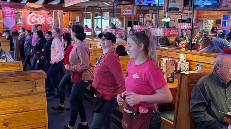 Servers line dancing at a Texas Roadhouse