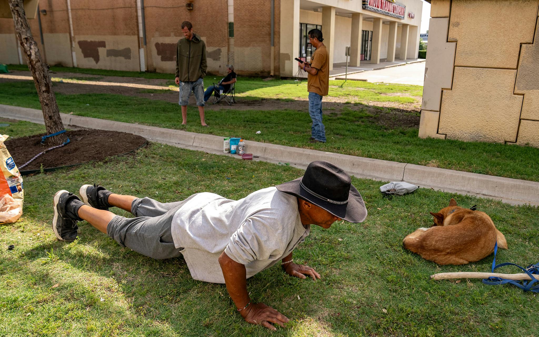May 31 10:05 A.M. Robert “Chief” Stallings, 61, who is originally from Kansas City, demonstrates his daily fitness routine behind the 7-11 at the southeast corner of Southwestern Boulevard and North Central Expressway. “I do sets of twenties, up to 500 pushups, I do crunches, I do leg lifts, I do calfs,” Stalling said. “I do many things and just off the curbs, the trees, the tire.”
