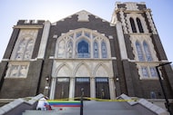 Robert Garcia applies orange paint to a front step of Oak Lawn United Methodist Church while...