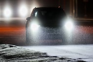 Sleet falls as motorists navigate a wintery mix covering the access road of US 75 near...