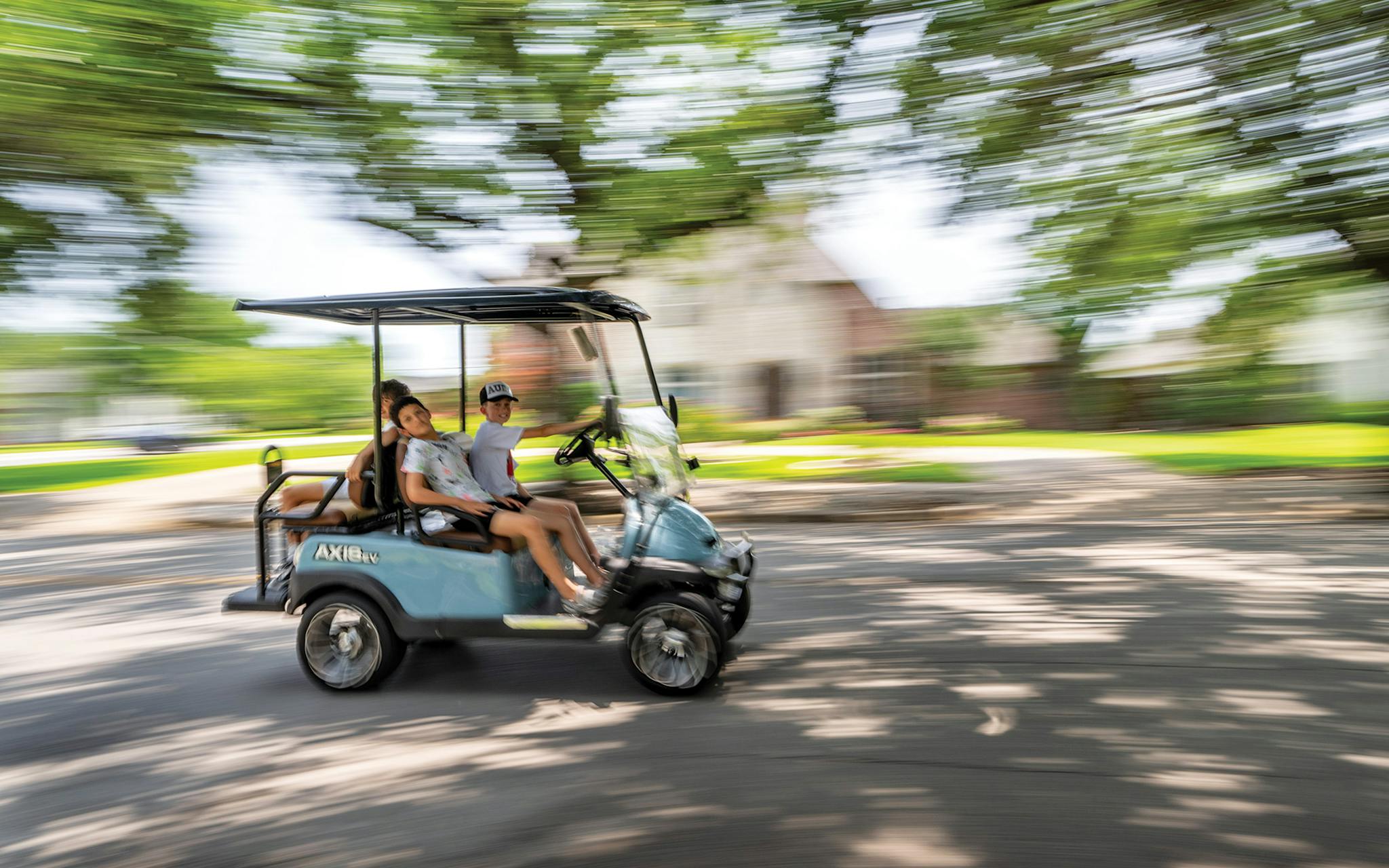 May 31 2:03 P.M. Jude Manaster (driving), Aitan Hochman (passenger seat), and Roey Minc (rear) heading down Northaven Road in the golf cart Jude bought with money he made reselling shoes.