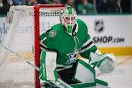 Dallas Stars goaltender Casey Desmith looks towards a team mate during an NHL hockey game...