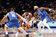 Utah Jazz forward Brice Sensabaugh (28) tries to drive past Dallas Mavericks forward Caleb...