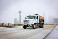 A sand truck makes its way through the icy Houston St., on Saturday, Jan. 24, 2026, in Dallas.