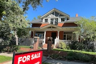 FILE - A for sale sign stands outside a home on the market in the Alamo Placita neighborhood...
