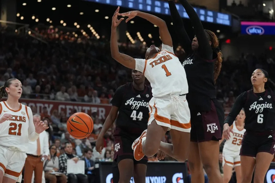 Texas guard Bryanna Preston (1) is fouled by Texas A&M center Emerald Parker (24) as she drives to the basket during the second half of an NCAA college basketball game in Austin, Texas, Sunday, Jan. 18, 2026. (AP Photo/Eric Gay)