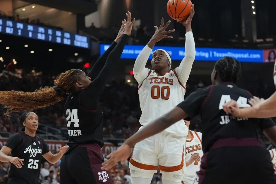 Texas center Kyla Oldacre (00) shoots over Texas A&M center Emerald Parker (24) during the second half of an NCAA college basketball game in Austin, Texas, Sunday, Jan. 18, 2026. (AP Photo/Eric Gay)