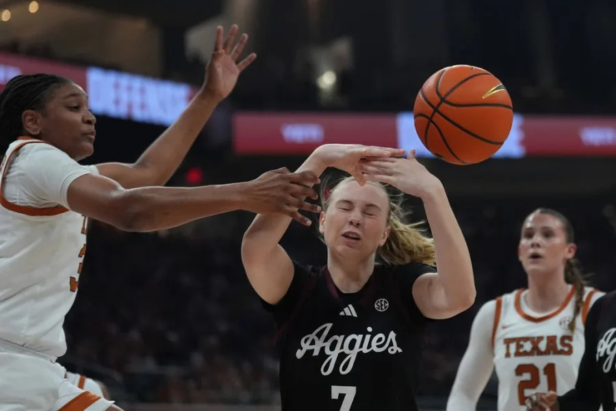 Texas A&M forward Pien Steenbergen (7) is blocked by Texas forward Madison Booker, left, during the first half of an NCAA college basketball game in Austin, Texas, Sunday, Jan. 18, 2026. (AP Photo/Eric Gay)