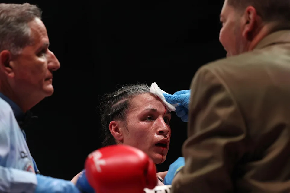 SAN JUAN, PUERTO RICO - JANUARY 03: Stephanie Han is checked by a ringside physician after suffering a cut against Holly Holm in the WBA World Lightweight Championship bout at Coliseo Roberto Clemente on January 03, 2026 in San Juan, Puerto Rico.