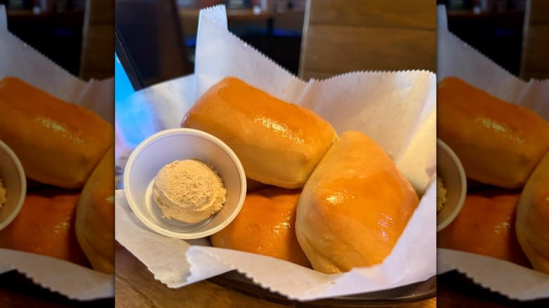 Basket of Texas Roadhouse rolls with butter