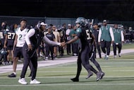 DeSoto's SaRod Baker (5) shakes hands with DeSoto head coach Claude Mathis after scoring a...