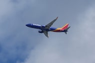 A Southwest Airlines plane is shown flying in San Bruno, Calif., Tuesday, Sept. 30, 2025....