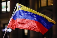 A Venezuelan flag waves during a 'No War with Venezuela’ protest at Main Street Garden in...