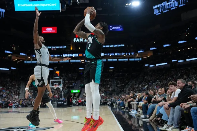 Jan 3, 2026; San Antonio, Texas, USA; Portland Trail Blazers guard Caleb Love (2) shoots over San Antonio Spurs guard De'aaron Fox (4) in the second half at Frost Bank Center.