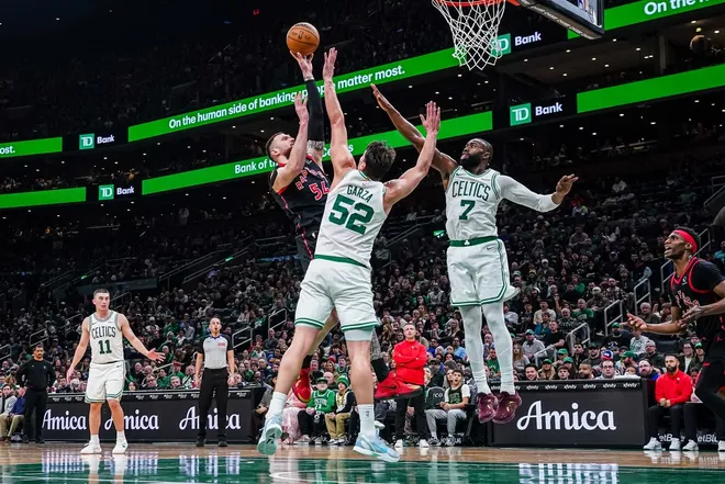 Jan 9, 2026; Boston, Massachusetts, USA; Toronto Raptors forward Sandro Mamukelashvili (54) shoots the ball against Boston Celtics guard Jaylen Brown (7) and center Luka Garza (52) in the second half at TD Garden.