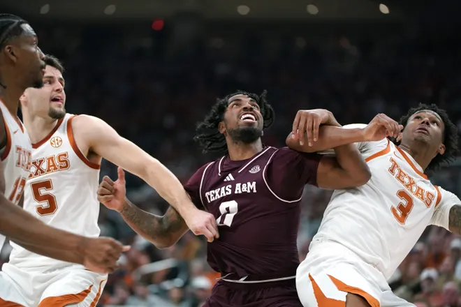 Jan 17, 2026; Austin, Texas, USA; Texas A&M Aggies guard Marcus Hill (0) is blocked by Texas Longhorns forward Camden Heide (5) and guard Dailyn Swain (3) during the first half at Moody Center. Mandatory Credit: Dustin Safranek-Imagn Images
