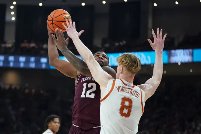 Jan 17, 2026; Austin, Texas, USA; Texas A&M Aggies forward Rashaun Agee (12) takes a lay up shot against Texas Longhorns center Matas Vokietaitis (8) during the first half at Moody Center. Mandatory Credit: Dustin Safranek-Imagn Images