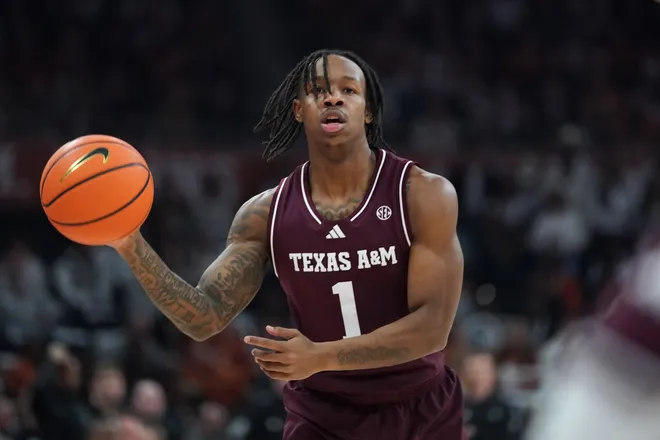 Jan 17, 2026; Austin, Texas, USA; Texas A&M Aggies guard Josh Holloway (1) looks to pass against the Texas Longhorns during the first half at Moody Center. Mandatory Credit: Dustin Safranek-Imagn Images