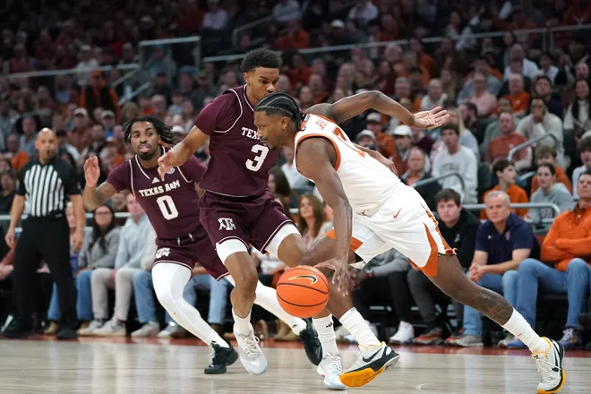 Jan 17, 2026; Austin, Texas, USA; Texas Longhorns guard Tramon Mark (12) dribbles against Texas A&M Aggies guard Ryan Griffen (3) during the first half at Moody Center. Mandatory Credit: Dustin Safranek-Imagn Images