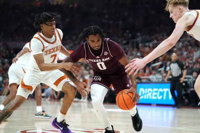 Jan 17, 2026; Austin, Texas, USA; Texas A&M Aggies guard Marcus Hill (0) dribbles against Texas Longhorns guard Simeon Wilcher (7) and center Matas Vokietaitis (8) during the first half at Moody Center. Mandatory Credit: Dustin Safranek-Imagn Images